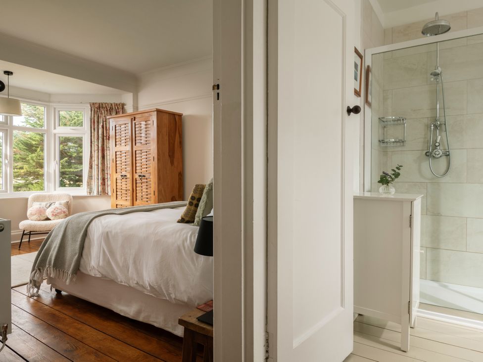 A bedroom with a bed and wardrobe at Summerfield in Deganwy