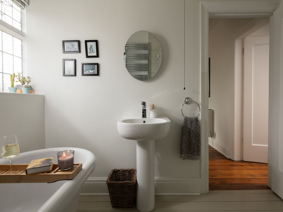A bathroom with a bathtub and sink at Summerfield in Deganwy