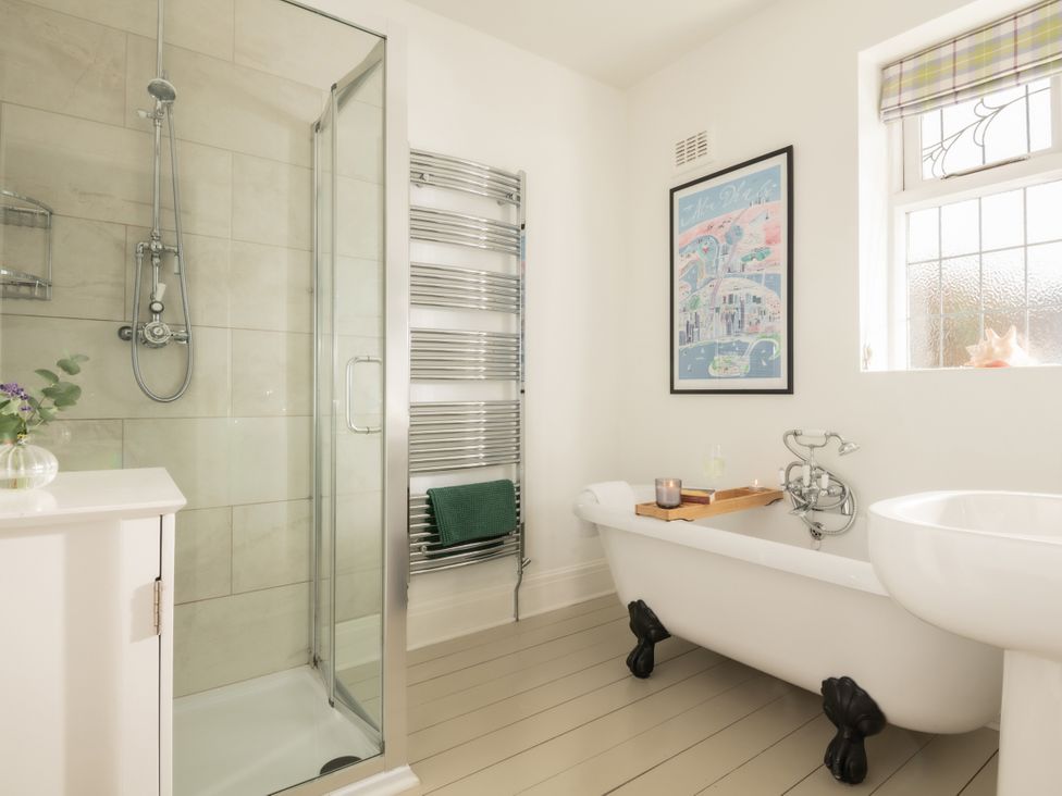 A bathroom featuring a bathtub and shower at Summerfield in Deganwy