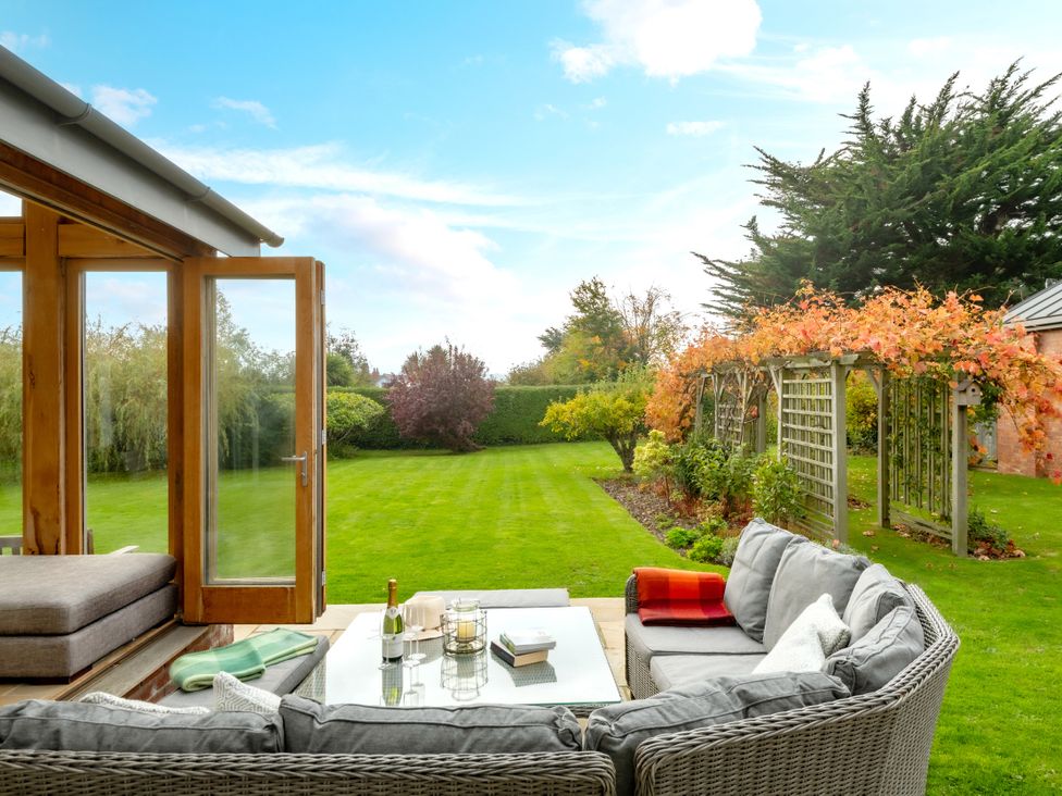 A garden with a seating area and a view at Summerfield in Deganwy