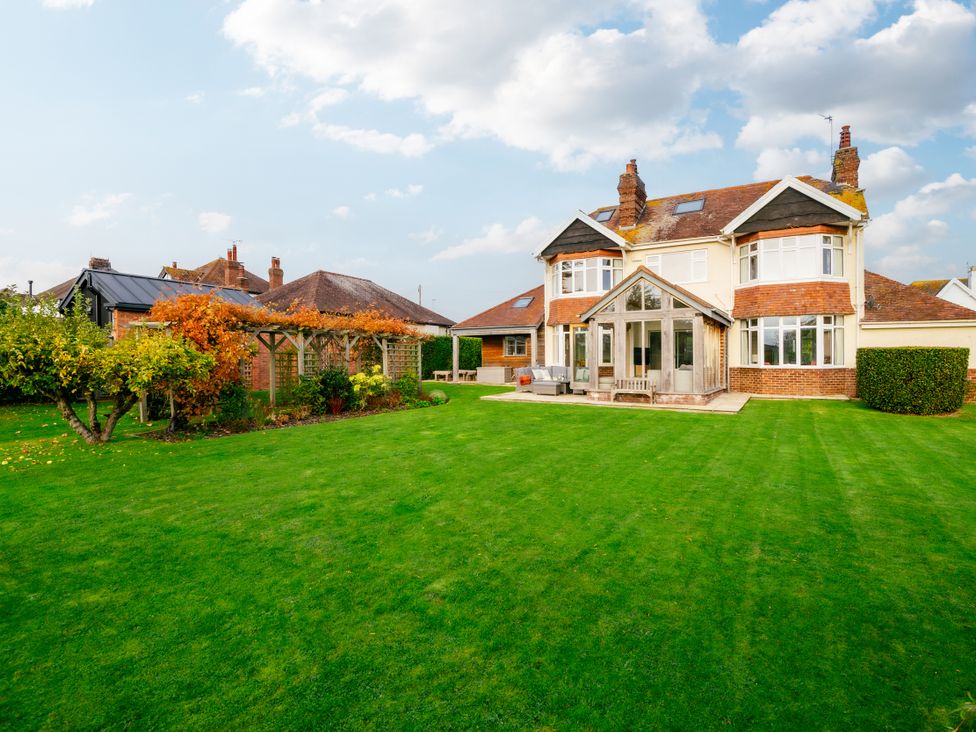 A house with a garden and patio area at Summerfield in Deganwy