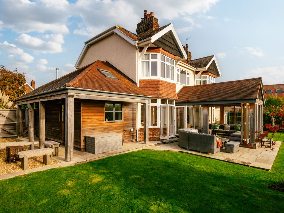 A house with a garden and patio seating area at Summerfield in Deganwy