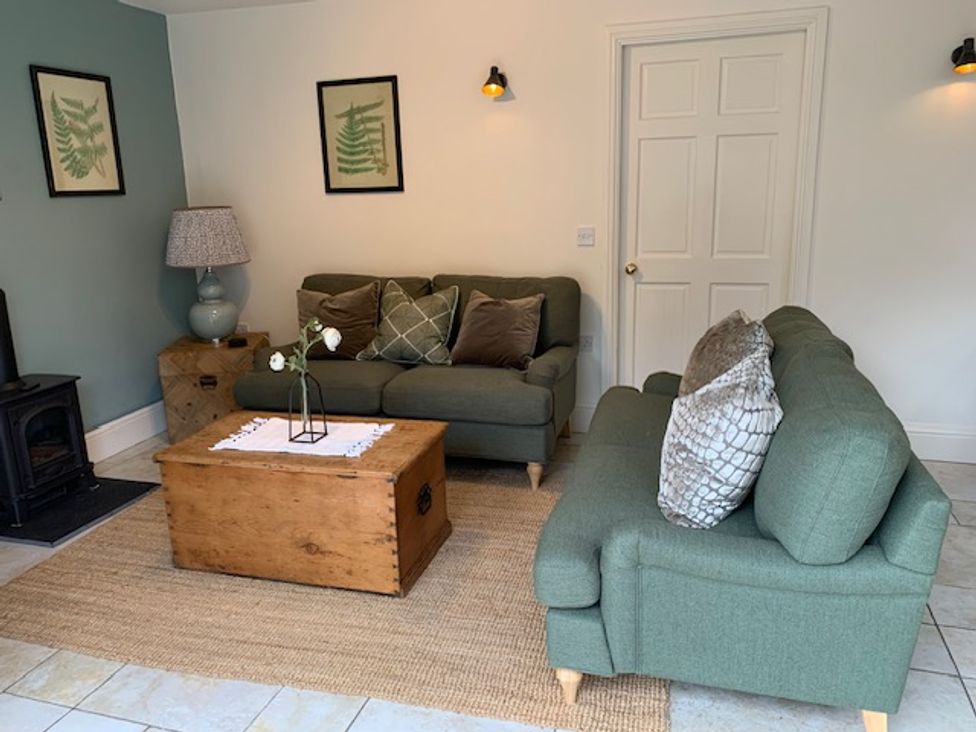 A living room with sofas and a coffee table at The Honey Pot Garndolbenmaen