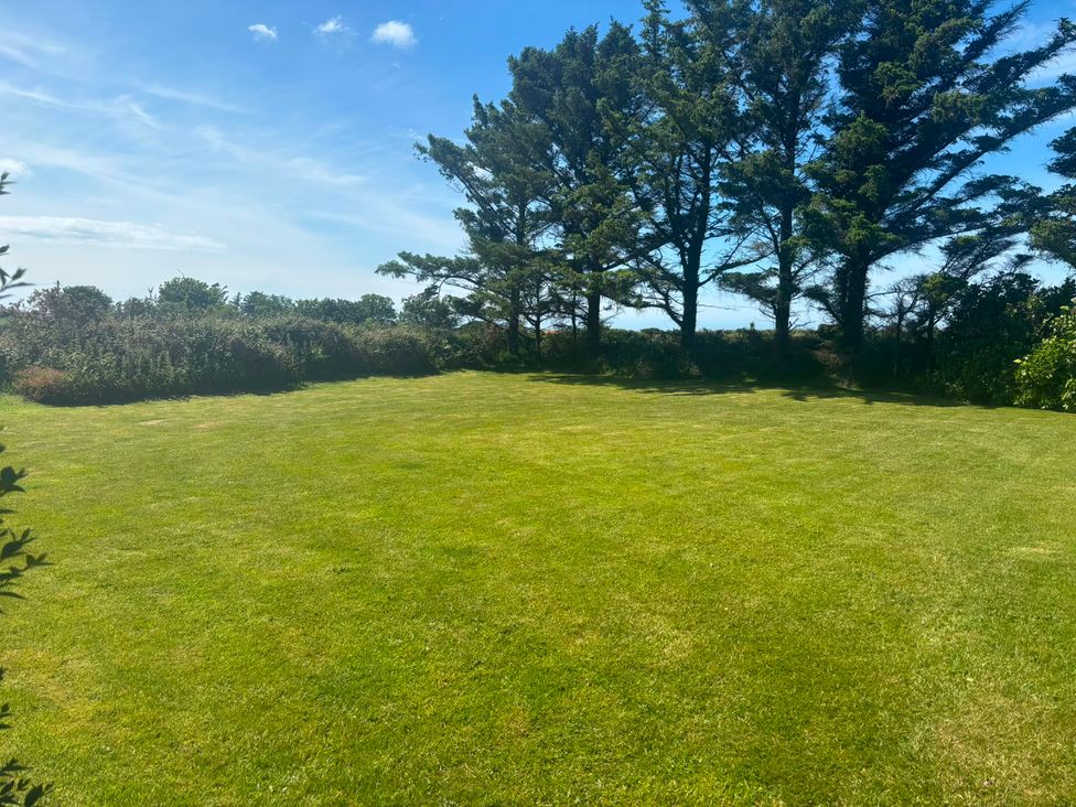A garden with grass and trees at Ty Bryn - Nefyn in Morfa Nefyn