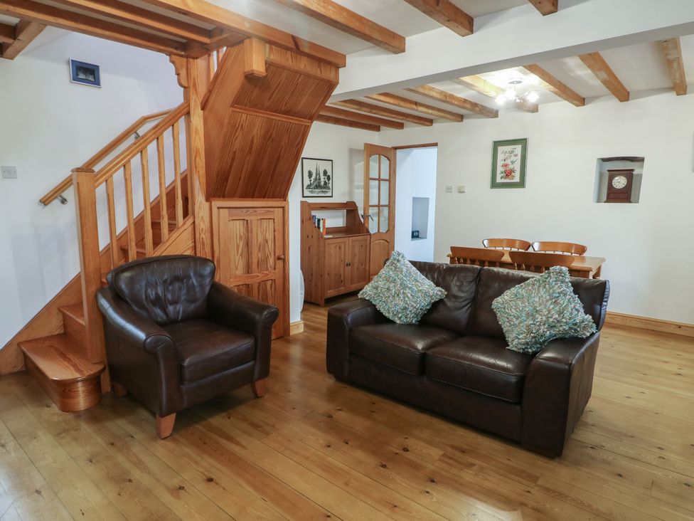 A living room with a sofa and armchairs at Tyn y Mynydd in Bull Bay