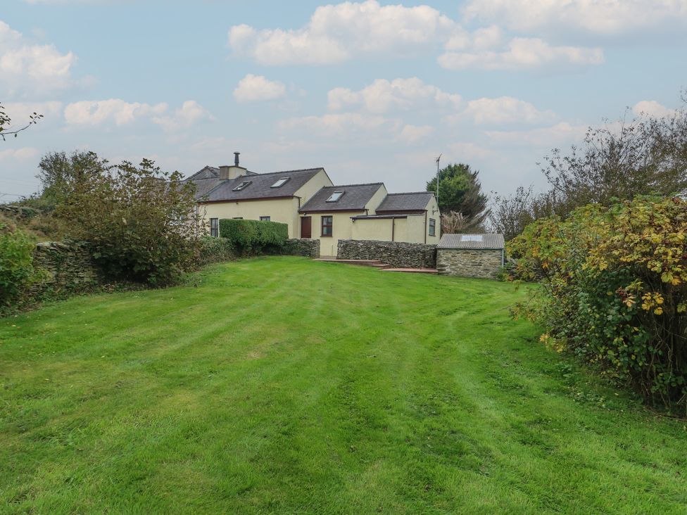 A house with garden and pathway at Tyn y Mynydd Bull Bay