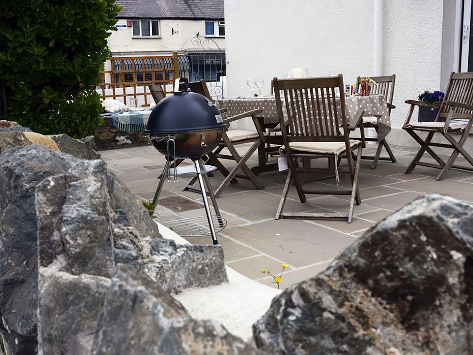 An outdoor area with a grill and seating at West View in Rhosneigr