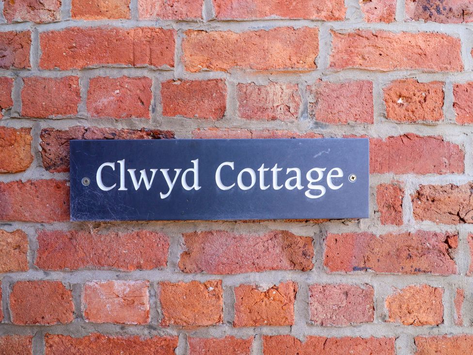 A nameplate on a brick wall at Clwyd Cottage St Asaph