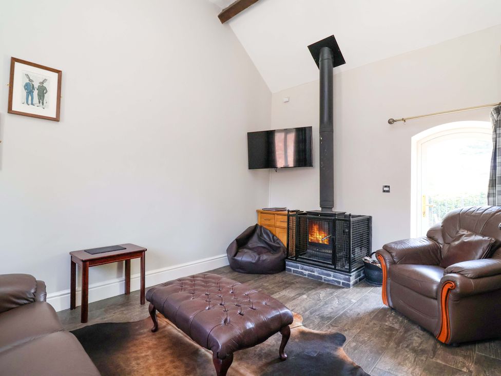 A living room with a sofa and coffee table at Clwyd Cottage St Asaph