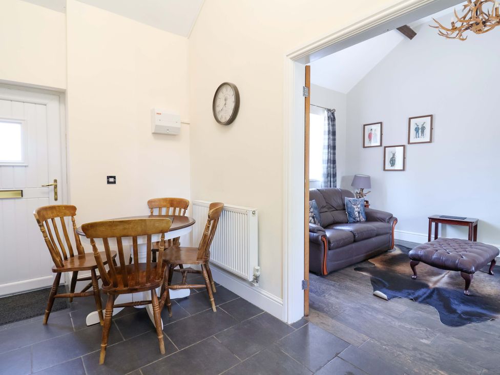 A dining area with a table and chairs at Clwyd Cottage in St Asaph