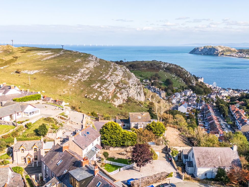 An ocean view with houses and hills at Ty Bach, Great Orme in Llandudno