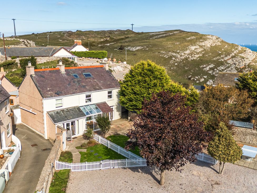 A house with a garden and trees at Ty Bach, Great Orme, Llandudno