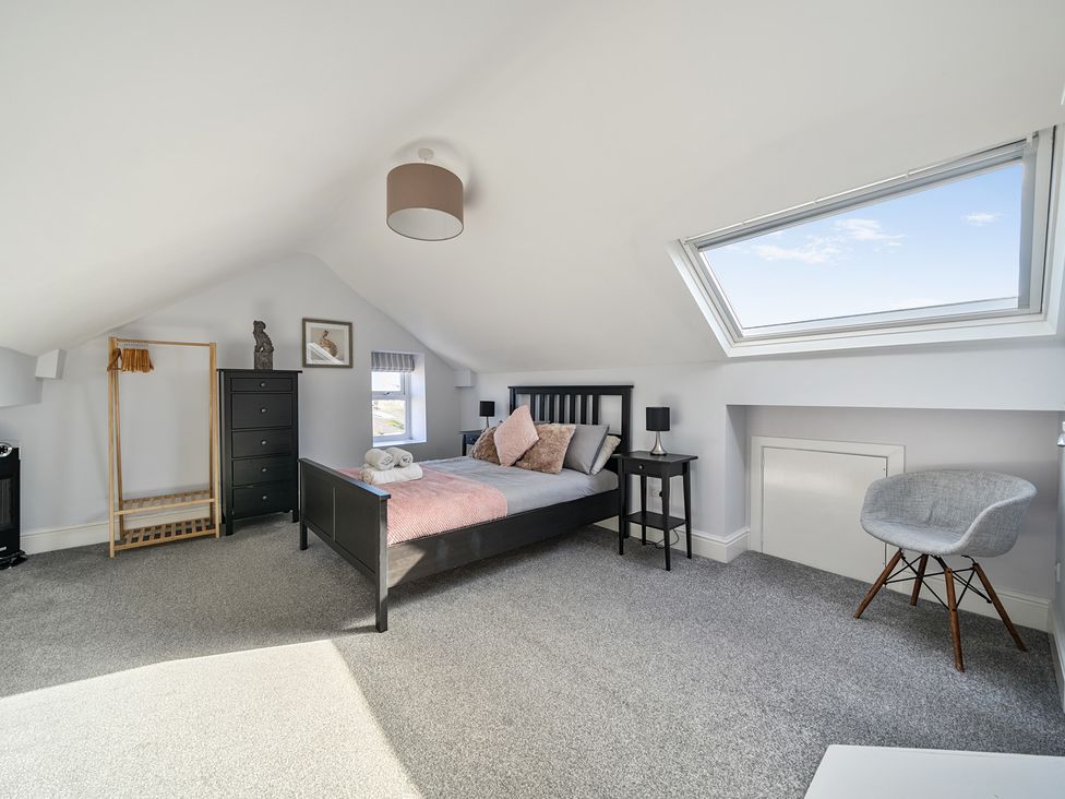 A bedroom with a bed and dresser at Ty Mawr, Great Orme in Llandudno