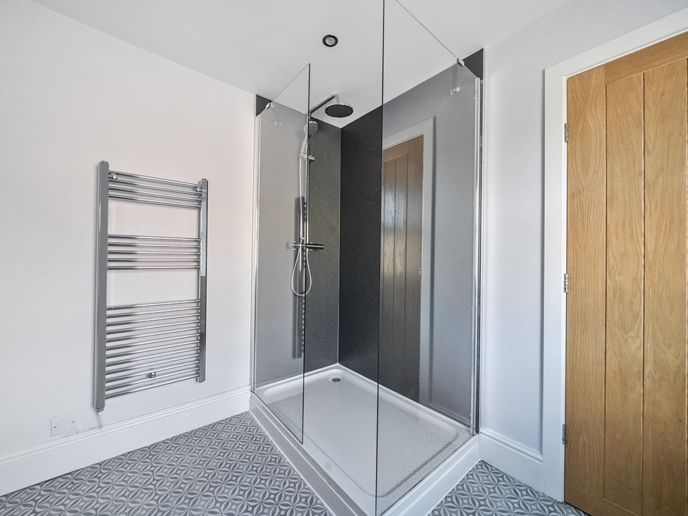 A bathroom with a shower and towel radiator at Ty Mawr, Great Orme in Llandudno