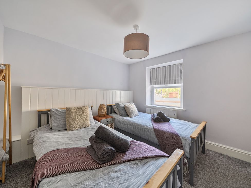 A bedroom with two beds and a window at Ty Mawr, Great Orme in Llandudno