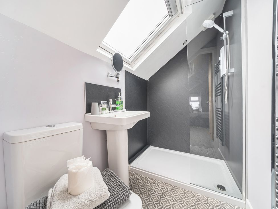 A bathroom with a shower and sink at Ty Mawr, Great Orme in Llandudno