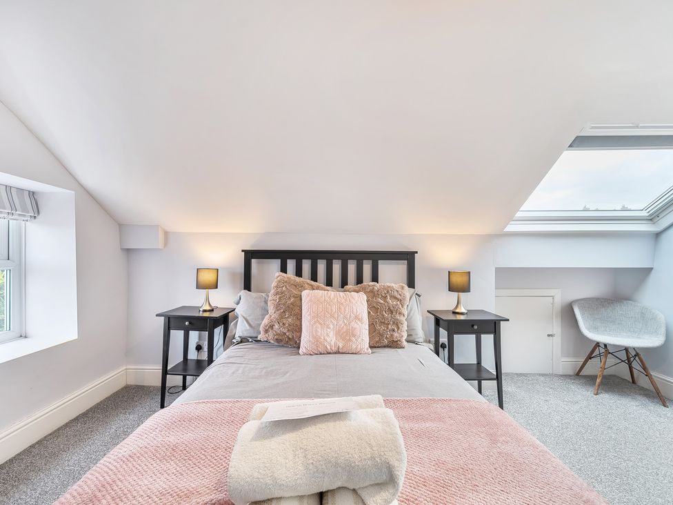 A bedroom with a bed and bedside tables at Ty Mawr, Great Orme in Llandudno