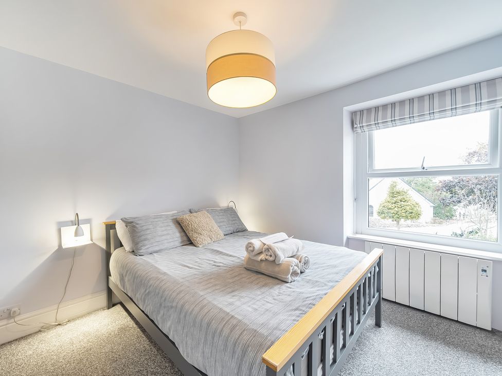 A bedroom with a bed and towels at Ty Mawr, Great Orme in Llandudno