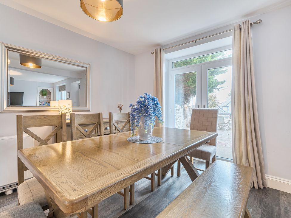 A dining room with a table and chairs at Ty Mawr, Great Orme Llandudno