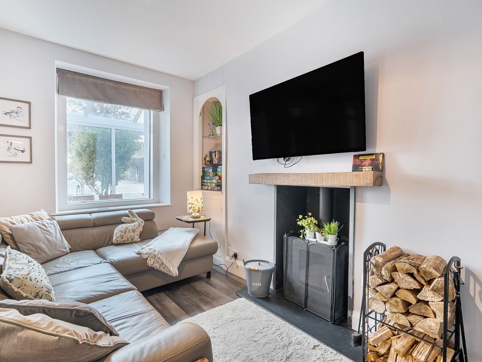 A living room with a sofa and television at Ty Mawr, Great Orme in Llandudno