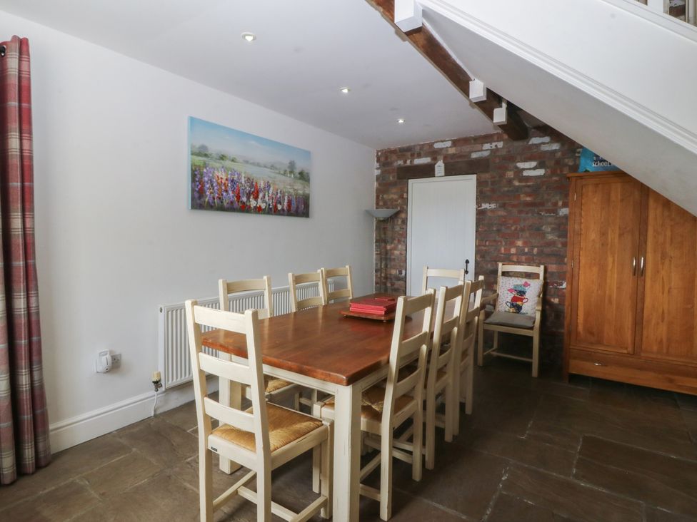 A dining room with a table and chairs at Llanallgo Church Rooms