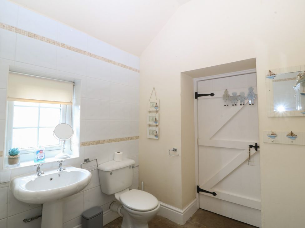 A bathroom with a sink and toilet at Llanallgo Church Rooms