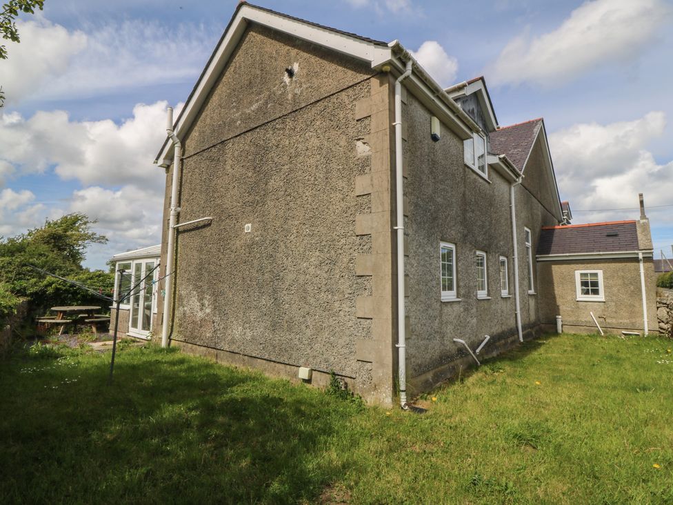 The exterior view of a house with a garden at Llanallgo Church Rooms