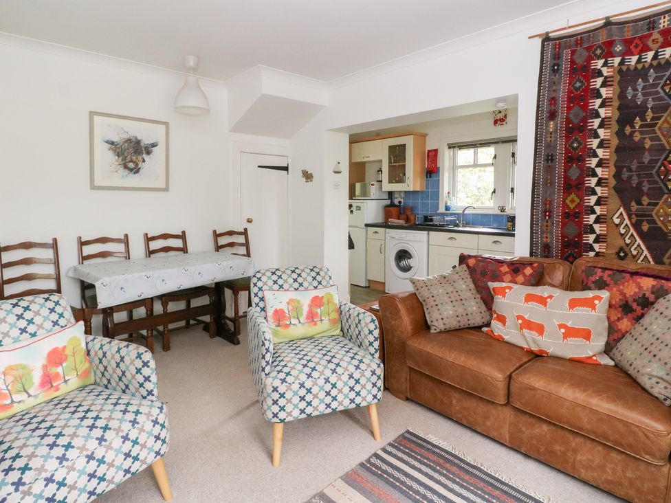 A living room with a sofa and chairs at Tower Lodge in Lochawe