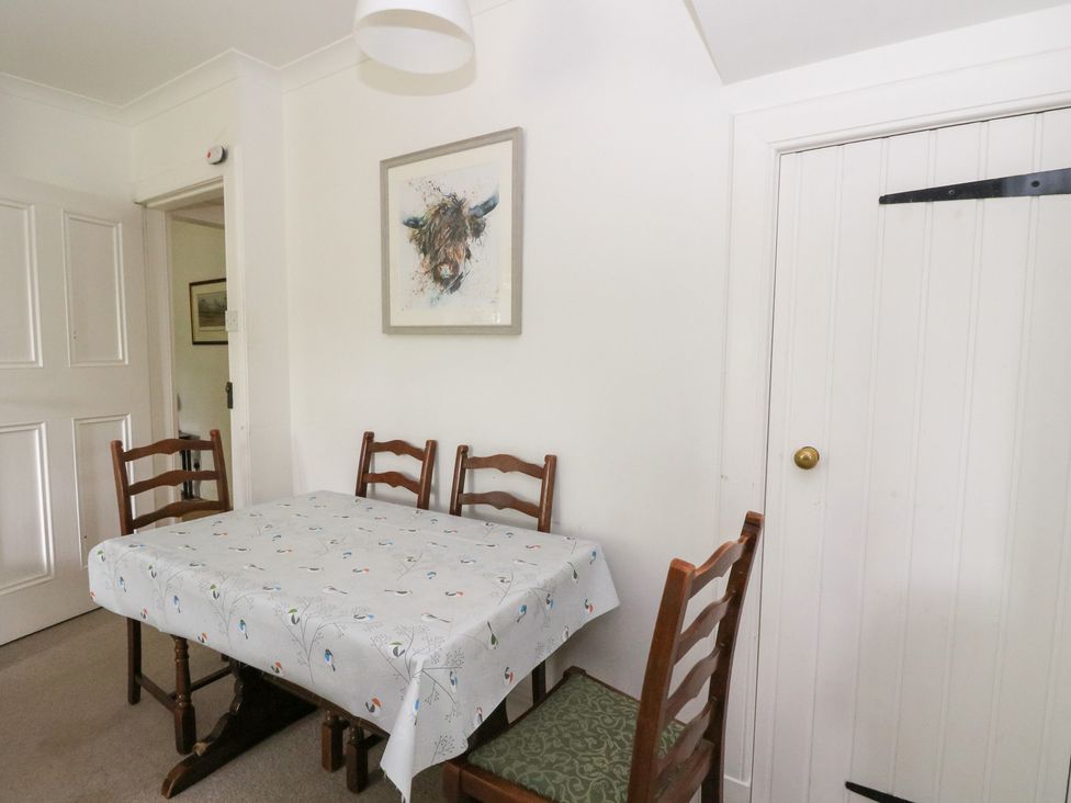 A dining room with a table and chairs at Tower Lodge in Lochawe