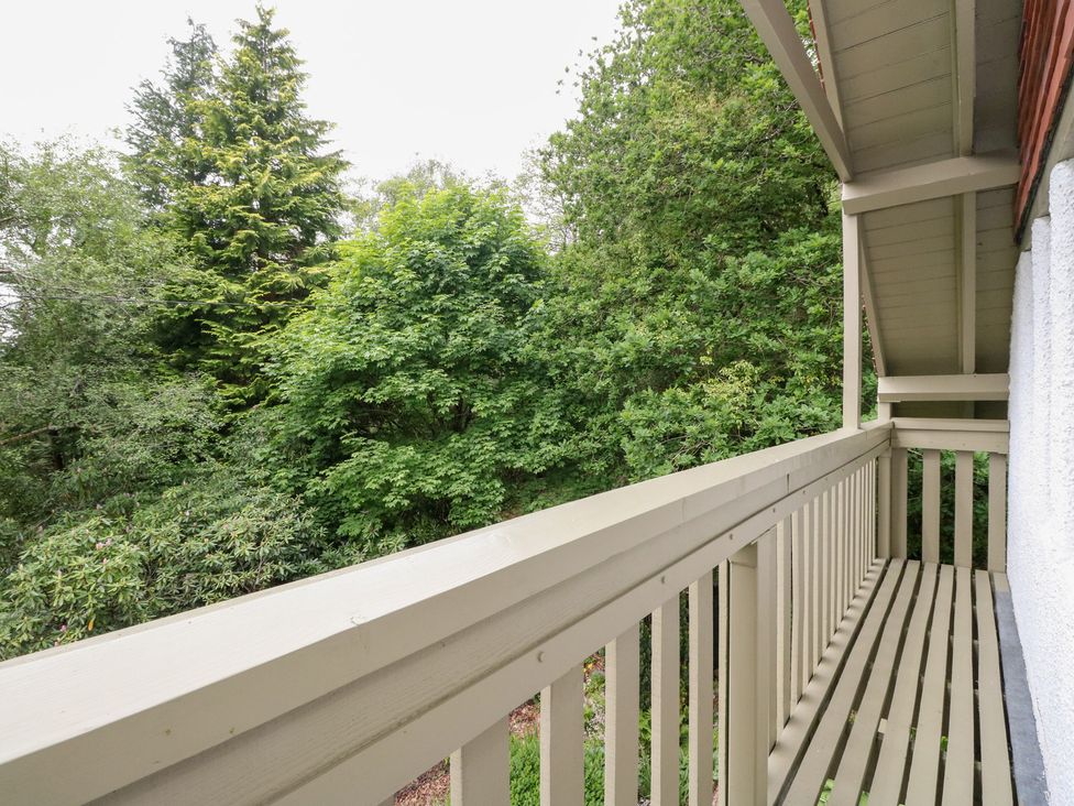 A balcony overlooking trees at Tower Lodge in Lochawe