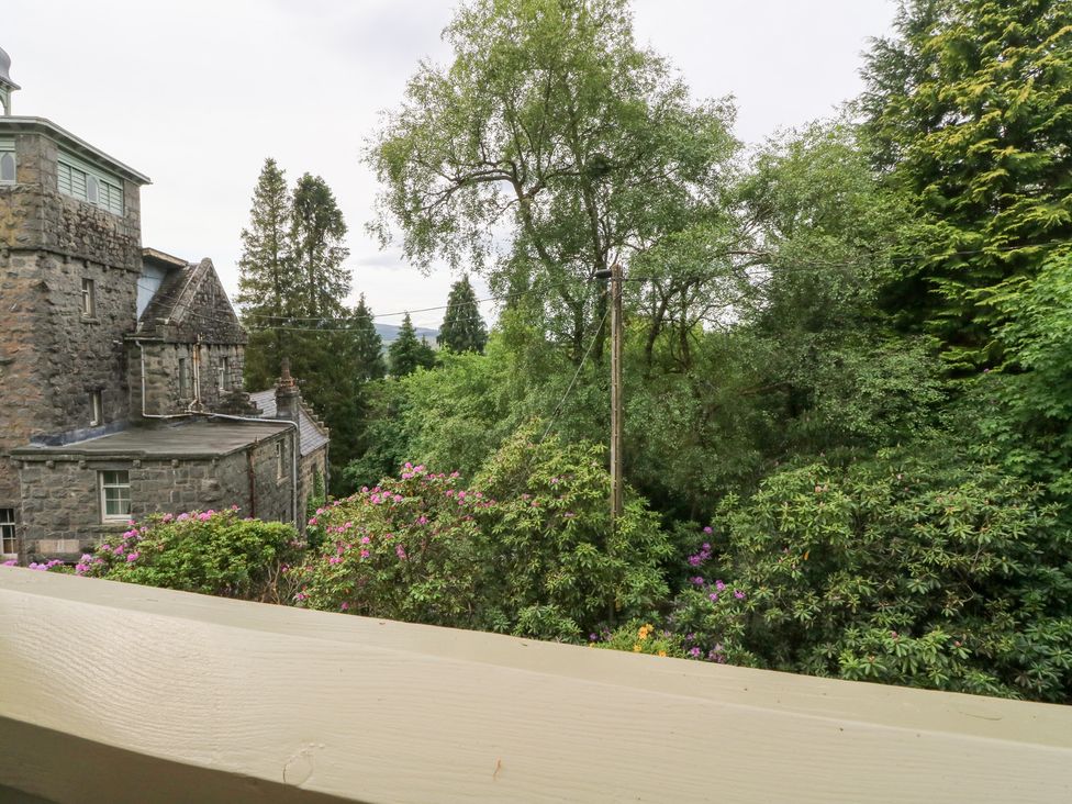 A view of a stone building and greenery at Tower Lodge Lochawe