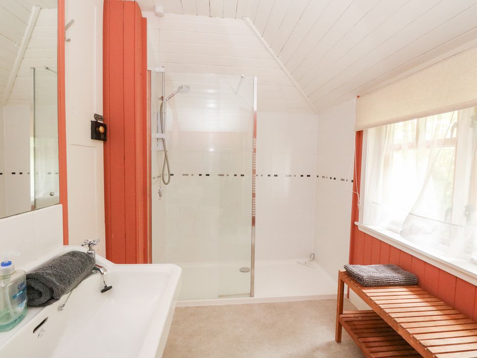 A bathroom with a shower and bathtub at Tower Lodge in Lochawe