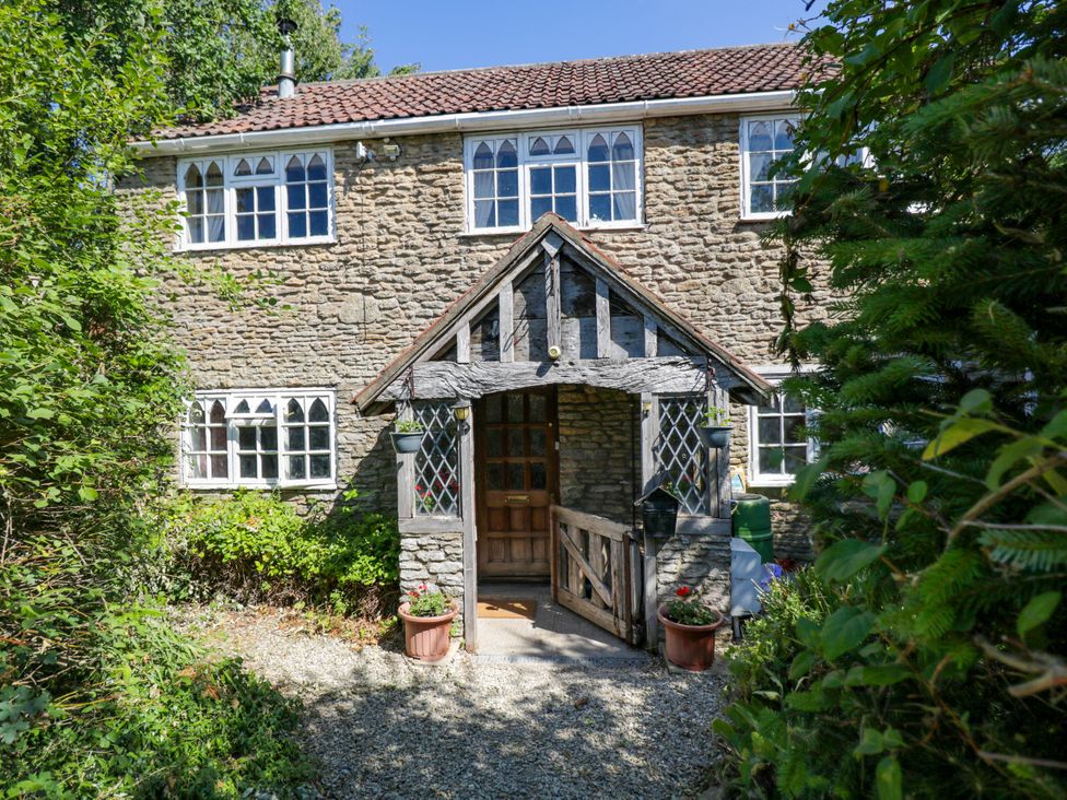 A house with a front entrance and garden at Ivy Cottage in Woolverton near Beckington
