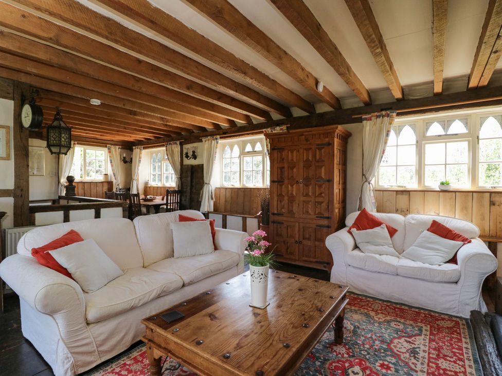 A living room with sofas and a coffee table at Ivy Cottage in Woolverton near Beckington