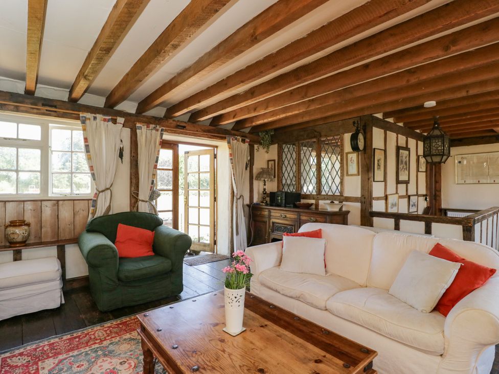 A living room with a sofa and armchair at Ivy Cottage in Woolverton near Beckington