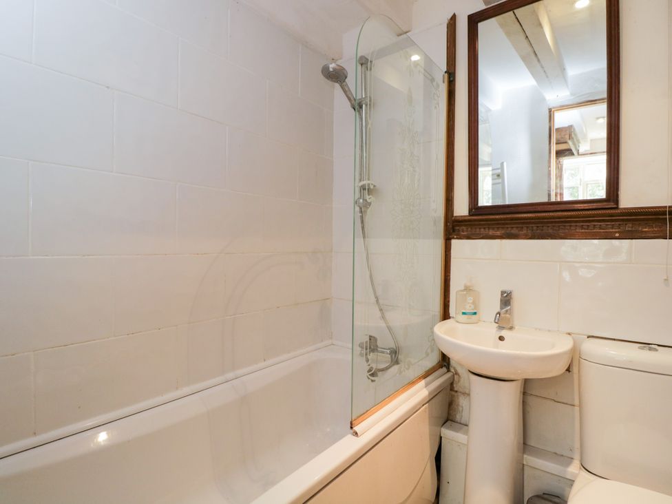 A bathroom with a bathtub, shower, sink, and toilet at Ivy Cottage in Woolverton near Beckington