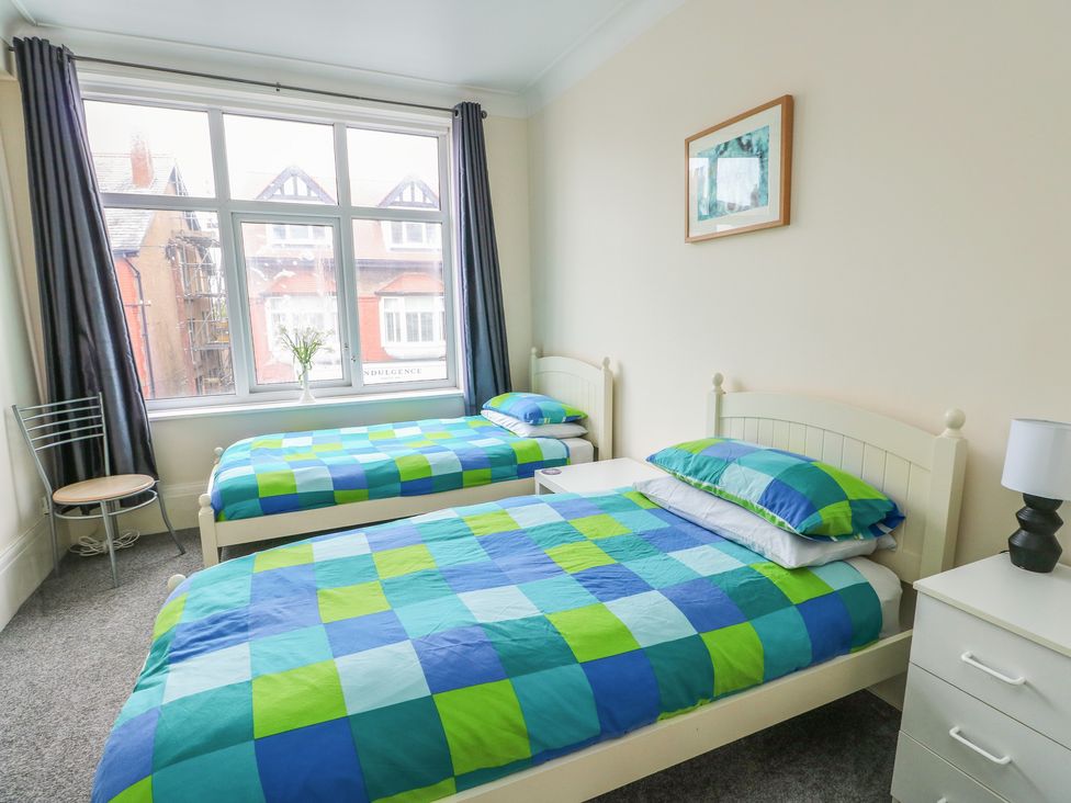 A bedroom with two beds and a lamp at Sea Breeze in Rhos-on-Sea