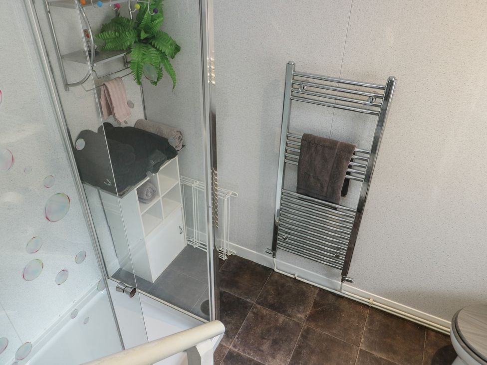 A bathroom with towel rack and shower at Sea Breeze, Rhos-on-Sea
