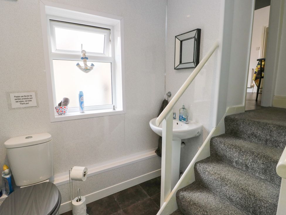 A bathroom with toilet and sink at Sea Breeze in Rhos-on-Sea