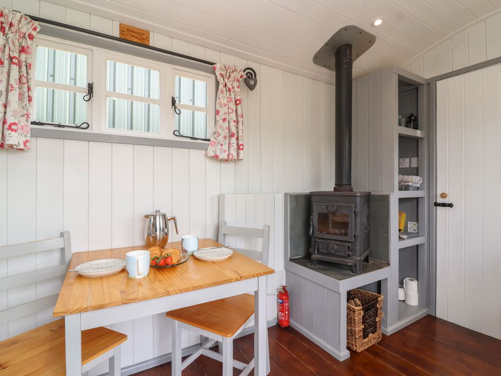 A dining area with a table and chairs at The Shepherds Hut in Chippenham