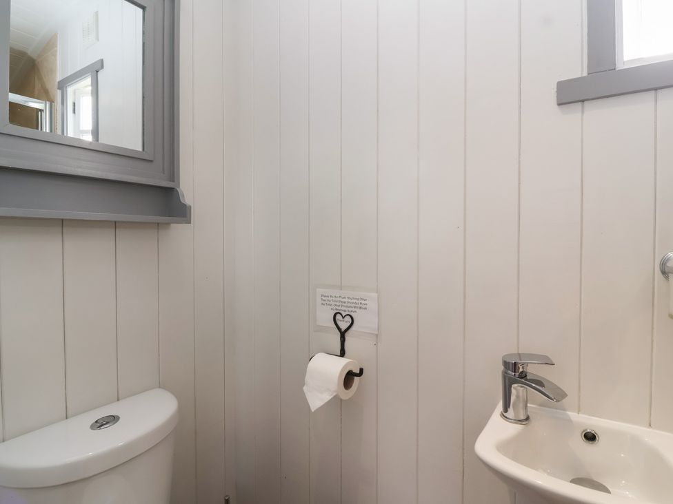 A bathroom with a sink and toilet at The Shepherds Hut in Chippenham