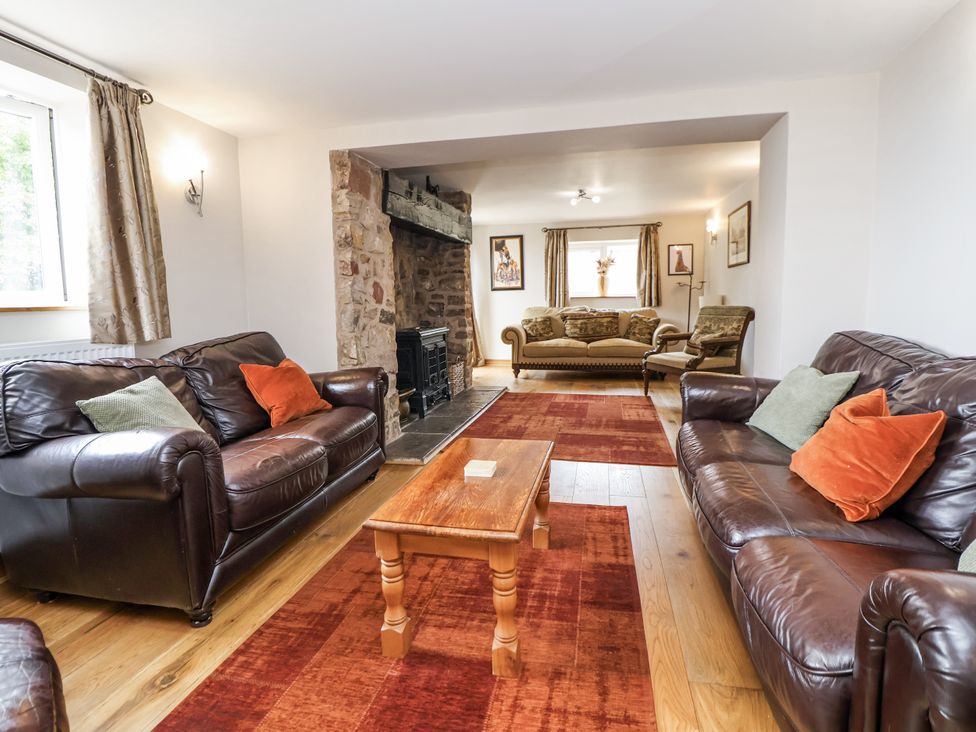 A living room with sofas and a fireplace at The Farmhouse Biddulph Moor near Biddulph