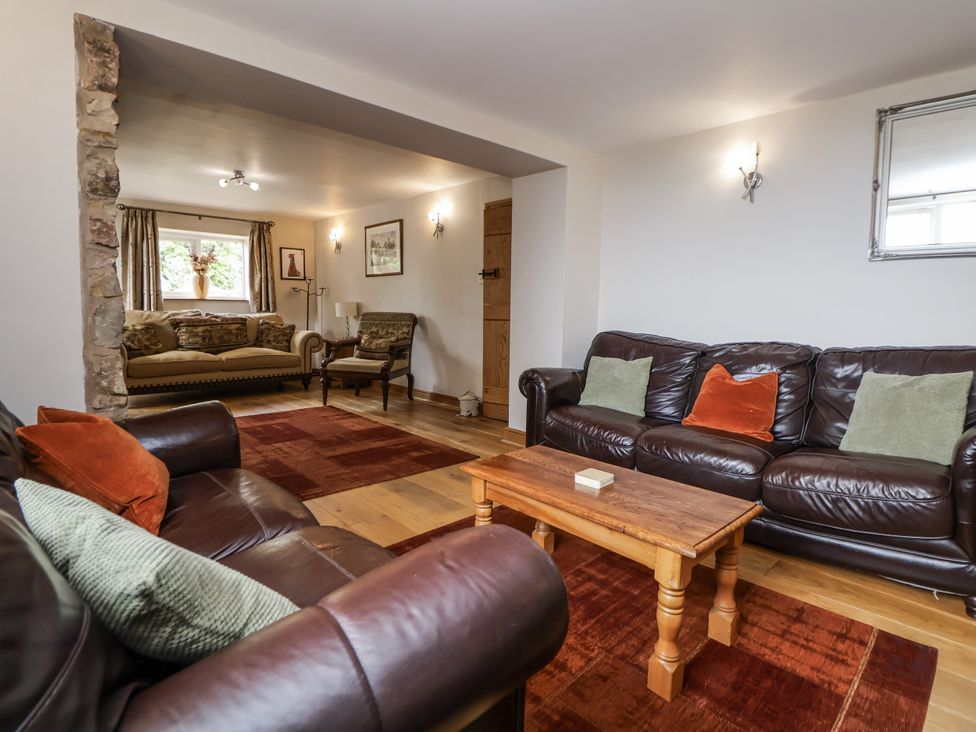 A living room with a sofa and coffee table at The Farmhouse in Biddulph Moor near Biddulph