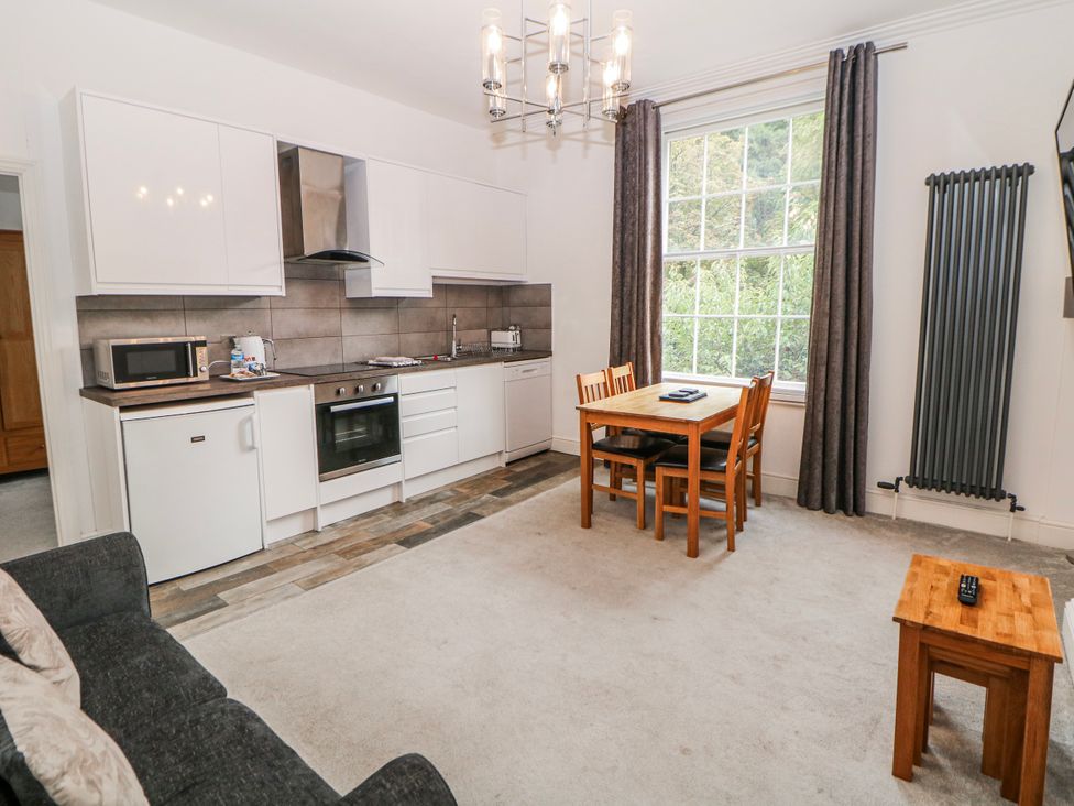 A kitchen with a table and chairs at Gulliver's (76) Matlock