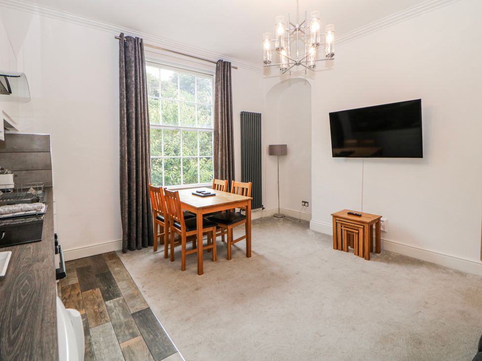 A dining room with table and chairs at Gulliver's (76) Matlock