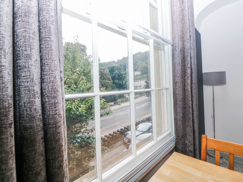 A window with curtains and a table in a dining room at Gulliver's (76) Matlock