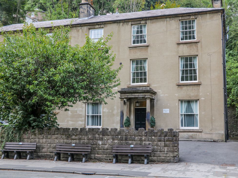 A building with benches and trees at Abraham in Matlock