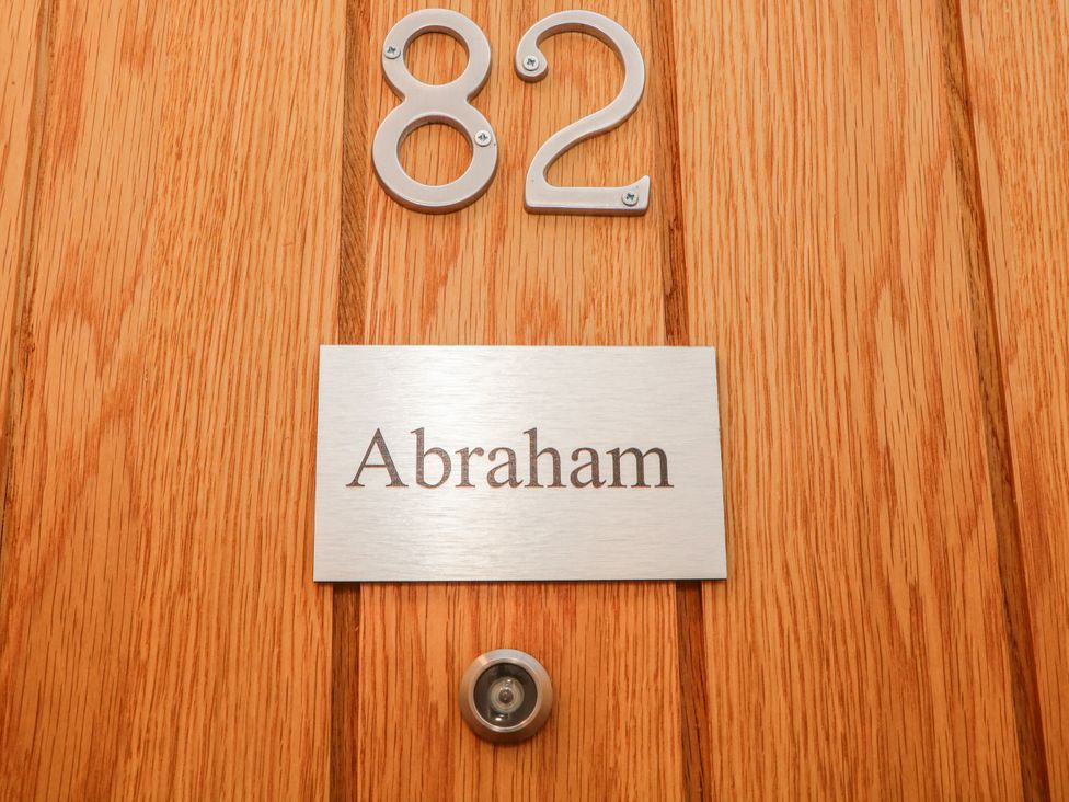 A door with number 82 and a name plaque at Abraham in Matlock