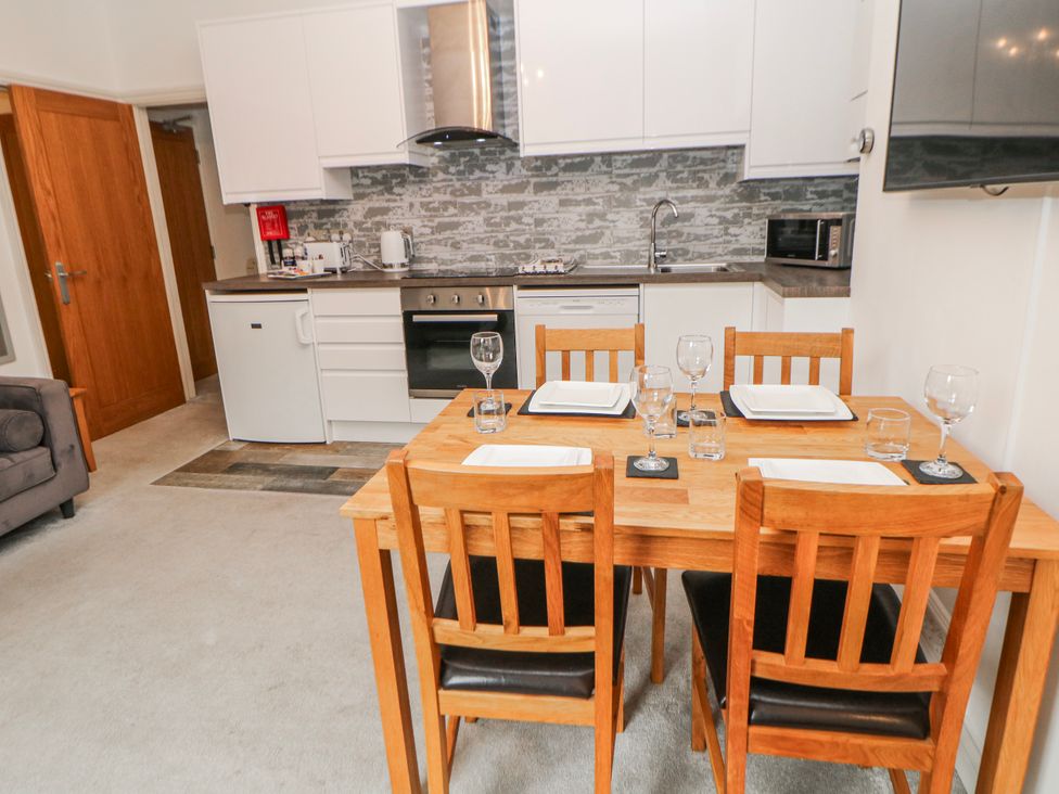 A kitchen with a dining table and chairs at Abraham in Matlock
