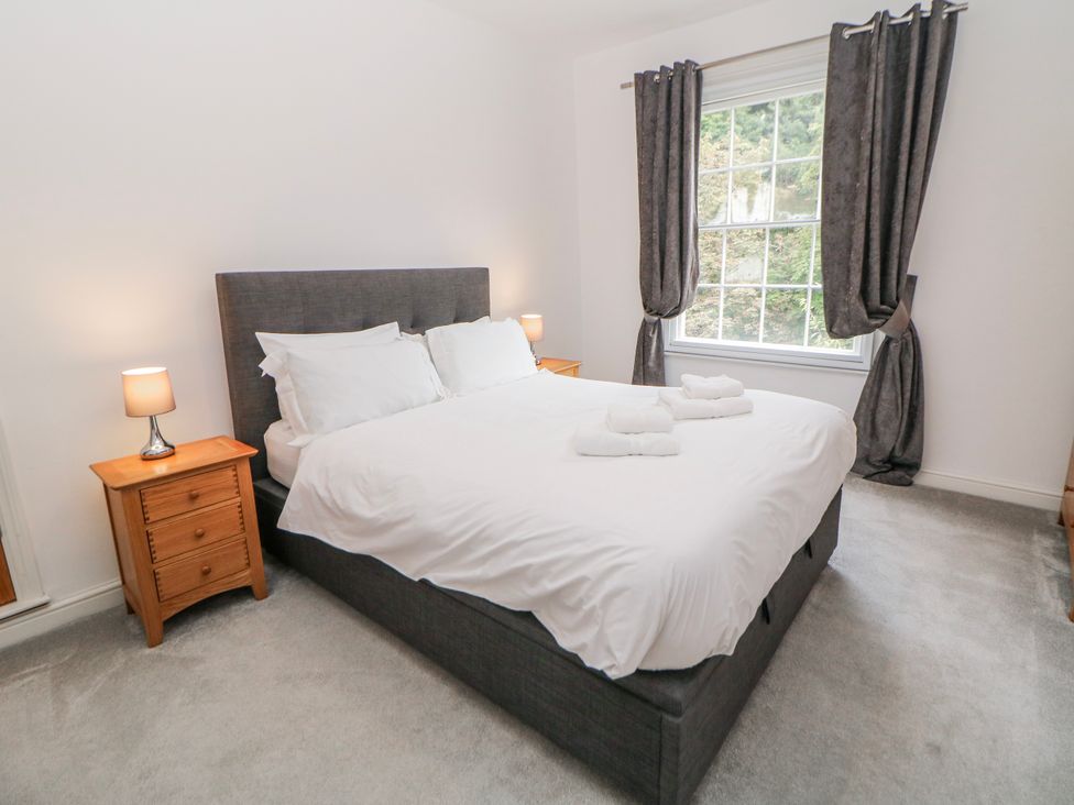 A bedroom with a bed and nightstands at Abraham in Matlock